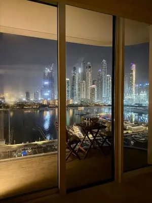 a view of a city skyline from a window at Ultra Luxury Emaar Beachfront Flat With Private Beach in Dubai