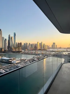 a view of a city with cars parked in a harbor at Ultra Luxury Emaar Beachfront Flat With Private Beach in Dubai