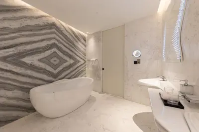 a bathroom with a white tub and a sink at The Opus Residences 1 Bedroom in Dubai