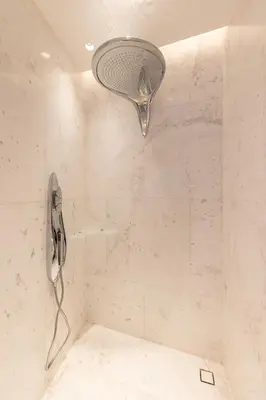 a shower with a shower head in a bathroom at The Opus Residences 1 Bedroom in Dubai