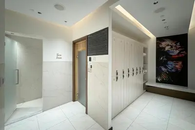 a bathroom with a walk in shower and a walk in closet at The Opus Residences 1 Bedroom in Dubai
