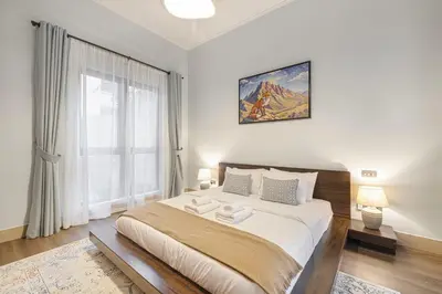 a bedroom with a large bed and a window at Massive 2,000 sqft 1BR with Private Terrace & BBQ in Dubai