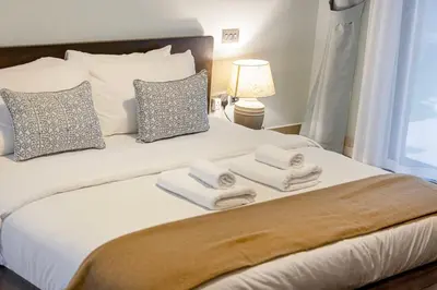 a bedroom with a bed with towels on it at Massive 2,000 sqft 1BR with Private Terrace & BBQ in Dubai