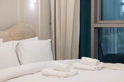 a hotel room with two towels on a bed at Modern 2BR, Burj & Fountains View, Dubai Mall 2 Minutes Walk in Dubai