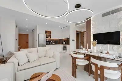 a living room with a white couch and a table at VIDA Marina Best Location NEW in Dubai