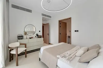 a white bedroom with a bed and a mirror at VIDA Marina Best Location NEW in Dubai
