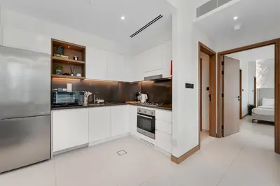 a kitchen with white cabinets and stainless steel appliances at VIDA Marina Best Location NEW in Dubai