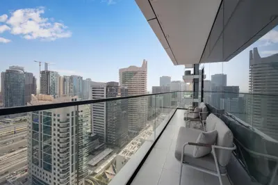 a balcony with chairs and a view of a city at VIDA Marina Best Location NEW in Dubai