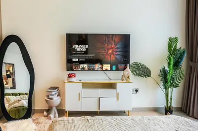 a bedroom with a tv on a wall at Modern Studio JVC I Sleeps 3 I Fully Furnished in Dubai