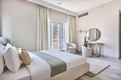 a bedroom with a large bed and a large window at Frank Porter - Concept Residences in Dubai