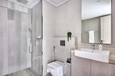 a bathroom with a toilet and a sink and a shower at Frank Porter - Concept Residences in Dubai
