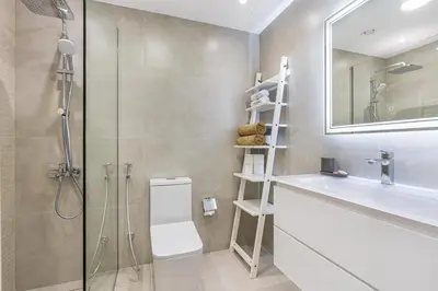 a bathroom with a shower and a toilet and a sink at Elegant Minimal Studio with Balcony in Dubai