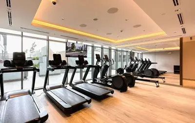 a gym with a bunch of exercise bikes in it at Luxury 1BR Featuring Guest - Study Room-SOBHA Waves in Dubai
