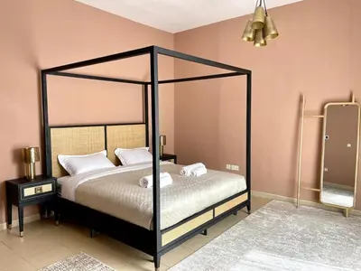 a bedroom with a black canopy bed with white pillows at Specious apartment in Sadaf 7 with Marina Views and Beach Access in Dubai