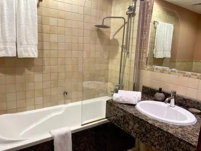 a bathroom with a sink and a bath tub and a sink at Specious apartment in Sadaf 7 with Marina Views and Beach Access in Dubai