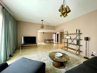 a living room with a couch and a table at Specious apartment in Sadaf 7 with Marina Views and Beach Access in Dubai