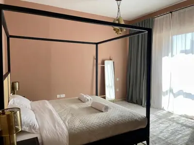 a bedroom with a canopy bed with white sheets at Specious apartment in Sadaf 7 with Marina Views and Beach Access in Dubai