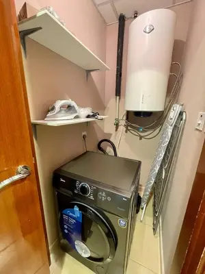 a washer and dryer in a small room at Specious apartment in Sadaf 7 with Marina Views and Beach Access in Dubai