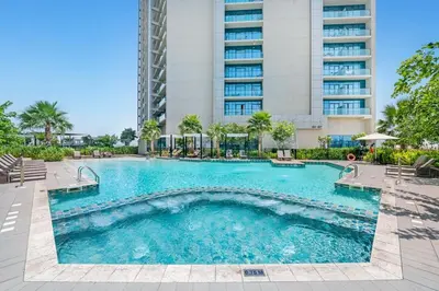 a swimming pool in front of a building at Stylish 2BR Canal Views, High Floor in Dubai