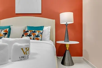 a bedroom with a bed and a table with a lamp at Stylish 2BR Canal Views, High Floor in Dubai