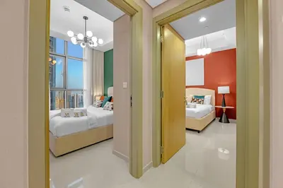 a bedroom with two beds and a window at Stylish 2BR Canal Views, High Floor in Dubai