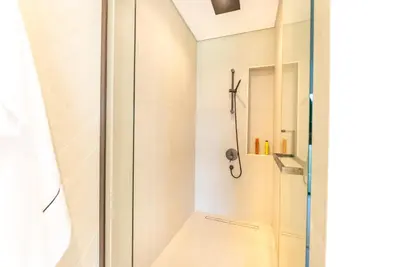 a shower with a glass door in a bathroom at Exquisite Jumeirah Bay Island Retreat 3 BR plus maids room in Dubai