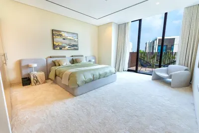 a bedroom with a bed and a large window at Exquisite Jumeirah Bay Island Retreat 3 BR plus maids room in Dubai
