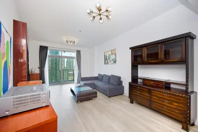 a living room with a tv and a couch at Stunning 1BR Apartment with Breathtaking Marina Views in Dubai