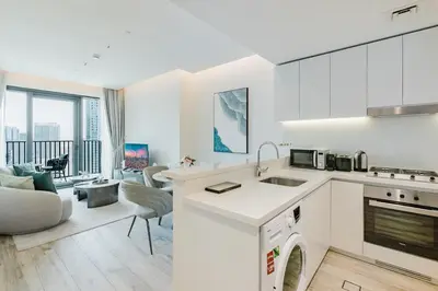 a kitchen and living room with a couch and a table at RH- Premium Furnished Living in Business Bay near to Burj Khalifa in Dubai