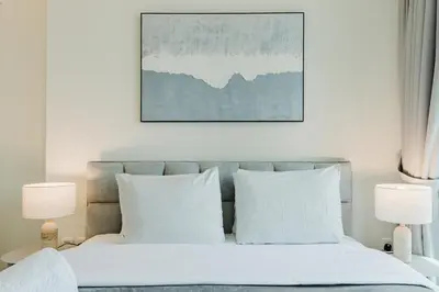 a bedroom with a bed with white sheets and pillows at RH- Premium Furnished Living in Business Bay near to Burj Khalifa in Dubai