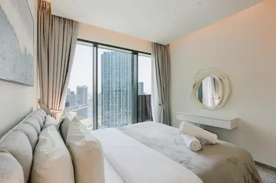 a bedroom with a large bed with a large window at RH- Premium Furnished Living in Business Bay near to Burj Khalifa in Dubai