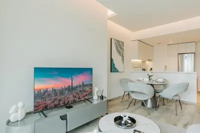 a living room with a tv and a table at RH- Premium Furnished Living in Business Bay near to Burj Khalifa in Dubai