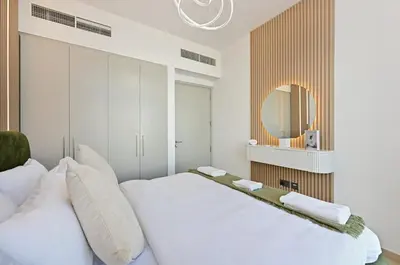 a bedroom with two beds and a mirror at Golden Stays - Tranquil 4BR Villa with Pool & Coastal Charms in Dubai