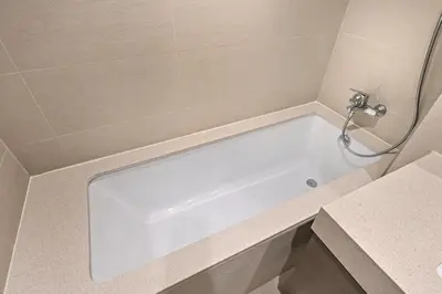 a white bath tub in a bathroom at Golden Stays - Tranquil 4BR Villa with Pool & Coastal Charms in Dubai