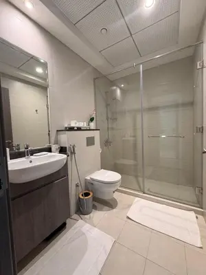 a bathroom with a shower and a toilet and a sink at Orchid residence 1BHK apartment in Dubai