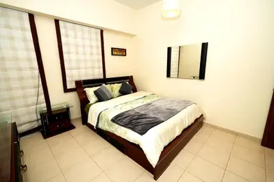 a bedroom with a bed and a mirror on the wall at Signature Luxury 2Bedroom Burj Khalifa Fountain View in Dubai