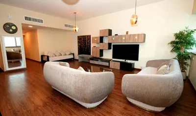 a living room with two couches and a flat screen tv at Signature Luxury 2Bedroom Burj Khalifa Fountain View in Dubai
