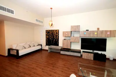 a living room with a couch and a flat screen tv at Signature Luxury 2Bedroom Burj Khalifa Fountain View in Dubai