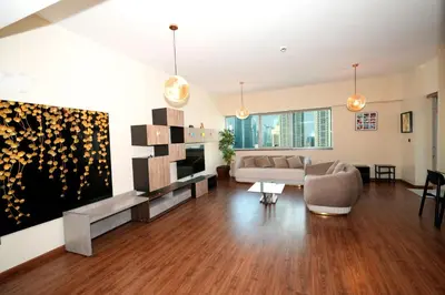 a living room with a couch and a television at Signature Luxury 2Bedroom Burj Khalifa Fountain View in Dubai