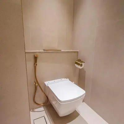a bathroom with a white toilet in a stall at Brand new apartment with luxury furniture in JVC in Dubai