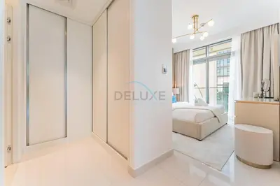 a bedroom with a bed and a sliding door at Panoramic Sea View, Offering Direct Access to Beach, Three Bedrooms and Assistant Room - Beach Vista Tower 2 by Deluxe Holiday Homes in Dubai