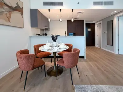 a kitchen and dining room with a table and chairs at Stylish 1 BR with hotel facilities and canal view in Dubai