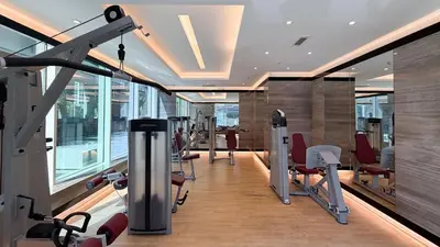 a gym with treadmills and exercise equipment in a building at Stylish 1 BR with hotel facilities and canal view in Dubai