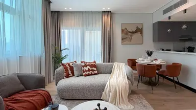 a living room with a couch and a table at Stylish 1 BR with hotel facilities and canal view in Dubai