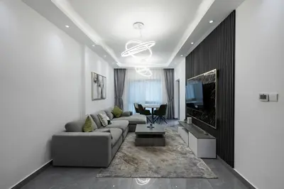 a living room with a couch and a tv at Dubai Marina - 1 BHK Elegant & Modern Apartment in Dubai