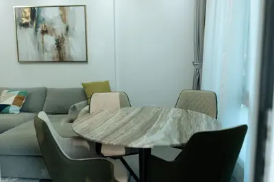 a living room with a table and a couch at Dubai Marina - 1 BHK Elegant & Modern Apartment in Dubai