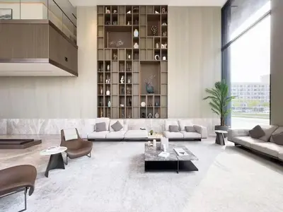 a living room with couches and chairs and a table at Stylish modern studio near Miracle Garden with Gym, Pool and Padel court in Dubai
