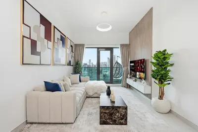 a living room with a couch and a table at Golden Stays - Opulent 2BR View Residence at The Bay in Dubai
