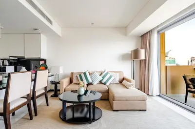 a living room with a couch and a table at Highest 1BR in JW Marriott Marina with Marina Views in Dubai