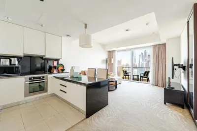 a kitchen with white cabinets and a view of the city at Highest 1BR in JW Marriott Marina with Marina Views in Dubai